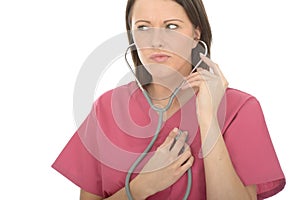 Portrait Of A Beautiful Young Concerned Female Doctor Listening To Her Own Heartbeat