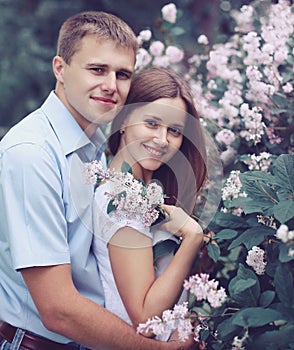 Portrait of beautiful young couple in the flowering spring