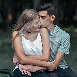 Portrait of a beautiful young couple in love. Teenagers. Man and woman outdoors