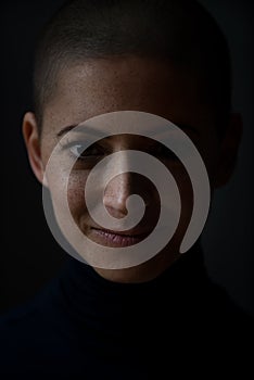 Portrait of a beautiful young courageous smiling female cancer patient, with shaved head. Woman, a cancer patient, portrait.