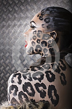 Portrait of beautiful young european model in cat make-up and bodyart