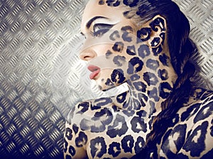 Portrait of beautiful young european model in cat make-up and bodyart