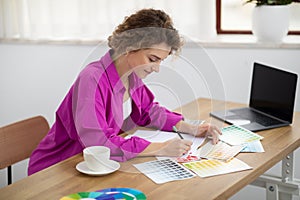 Portrait Of Beautiful Young Female Freelancer Working At Desk In Home Office