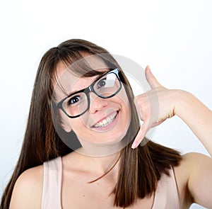 Portrait of beautiful young female making CALL ME gesture