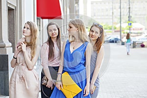 Portrait of a beautiful young four women walk on summer city