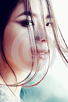 Portrait of a beautiful young girl of Asian appearance, close-up, outdoors photo