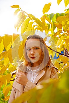 Portrait of  beautiful young girl in  autumn park