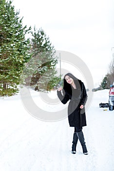 Portrait of a beautiful young girl on a background of a winter p