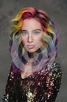 Portrait of a beautiful young girl with dyed colored hair. Hairstyle and makeup. Fashion shooting for the hairdresser