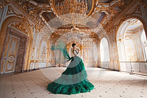 Portrait of a beautiful young girl in a Haute couture green dress