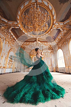 Portrait of a beautiful young girl in a Haute couture green dress photo
