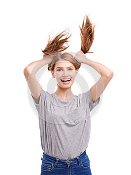 Portrait of a beautiful young girl holding her hair in tails, isolated on white background.