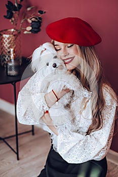 Portrait of beautiful young girl with a little white dog