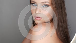 Portrait of a beautiful young girl model in stylish evening make up smoky eyes looks at the camera and posing. Eyes