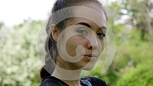 Portrait of a beautiful young girl, slow motion. European model woman model posing and turning on camera.