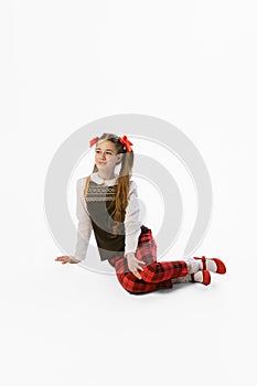 Portrait of beautiful young girl, teen in retro style clothes posing at white studio background. Concept of art, beuty