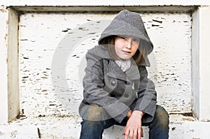 Portrait of a beautiful young girl in winter coat and jeans.