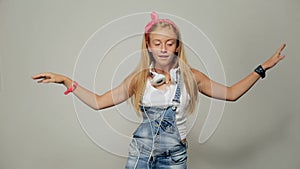 Portrait of a beautiful young girl woman listening to music, dancing