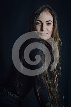 Portrait of a beautiful young Italian woman with very long hair smiling tenderly