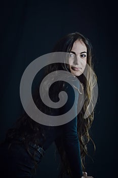 Portrait of a beautiful young Italian woman with very long hair smiling tenderly