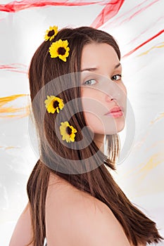 Portrait of beautiful young lady with flowers in her hair