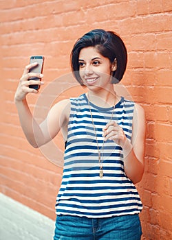 Portrait of beautiful young latin hispanic girl woman making selfie photo