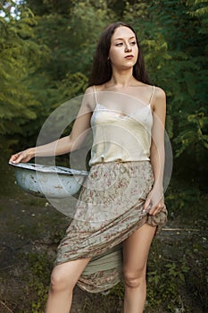 Portrait of a beautiful young laundress near the river