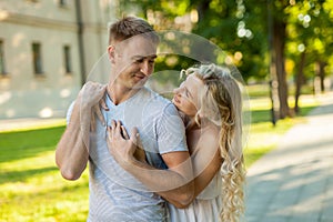 Portrait of beautiful young loving couple smiling outdoors