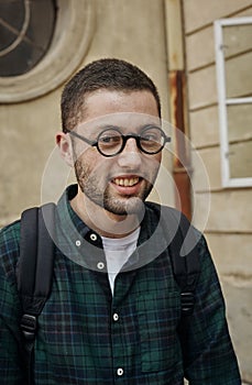 Portrait of beautiful young man in classic round glasses