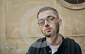 Portrait of beautiful young man in classic round glasses