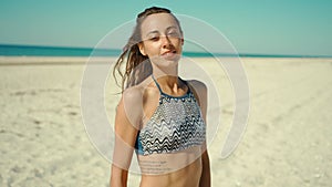 portrait of beautiful young mixed race woman laughing cheerful enjoying lifestyle on calm sunny sandy beach feminine