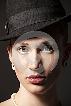 Portrait of a beautiful young model in black hat