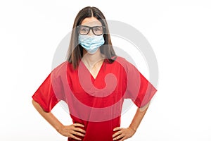 Portrait of beautiful young nurse wearing scrubs and face sterile mask