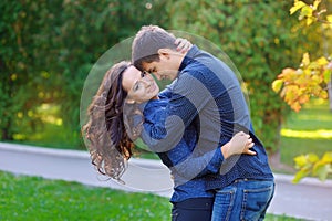 Portrait of beautiful young pair in a park