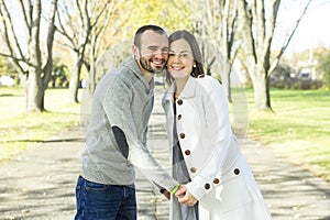 Portrait of beautiful young pair in a park