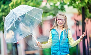 Portrait of beautiful young pre-teen girl with umbrella under rain