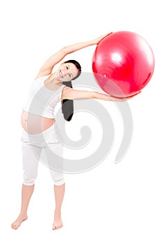 Portrait of a beautiful young pregnant woman executing exercises with fitball photo