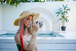 Portrait beautiful young red hair woman relax smile leisure around outdoor swimming pool nearly sea beach ocean for holiday vacati