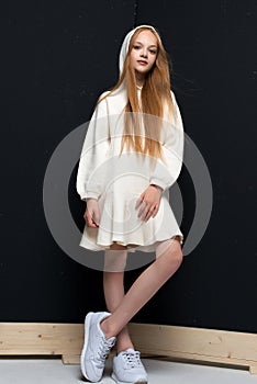 Portrait of beautiful young redhead girl posing in studio.