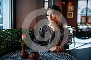 Portrait of beautiful young retro lady in cafe