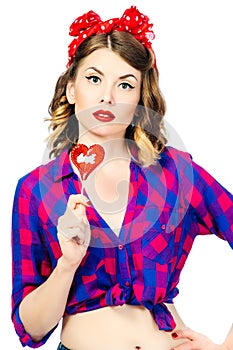 Portrait of beautiful young woman with vintage make-up and hairstyle with lollipop