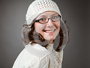 Portrait of a beautiful young smiling brunette wearing chochet h
