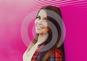 Portrait beautiful young smiling brunette woman on a pink background