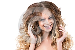 Portrait of beautiful young smiling girl with luxuriant hair curling.