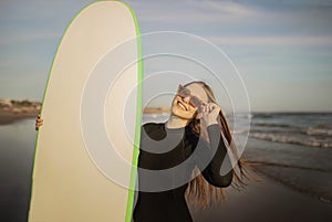 Portrait Of Beautiful Young Surfer Lady Holding Big Blank Surfboard