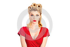 Portrait of beautiful young surprised woman, dressed in red pin-up dress. Caucasian blond model posing in retro fashion