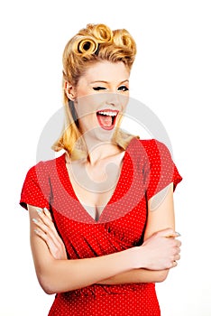 Portrait of beautiful young surprised woman, dressed in red pin-up dress. Caucasian blond model posing in retro fashion