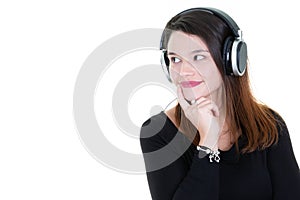 Portrait of beautiful young urban woman with headphones indoors listening music look side copy space