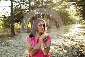 Portrait of beautiful young woman in against the sun background