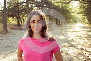 Portrait of beautiful young woman in against the sun background